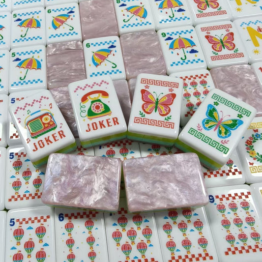 Scattered Retro Nostalgia mahjong tiles, white faces with macaron dot tiles, pizza tile, umbrella bamboo tiles, black cat crack tiles, butterfly flower tiles, rainbow N/E/W/S wind tiles and pink pearlescent marble backs with aqua-lime-pink side stripes