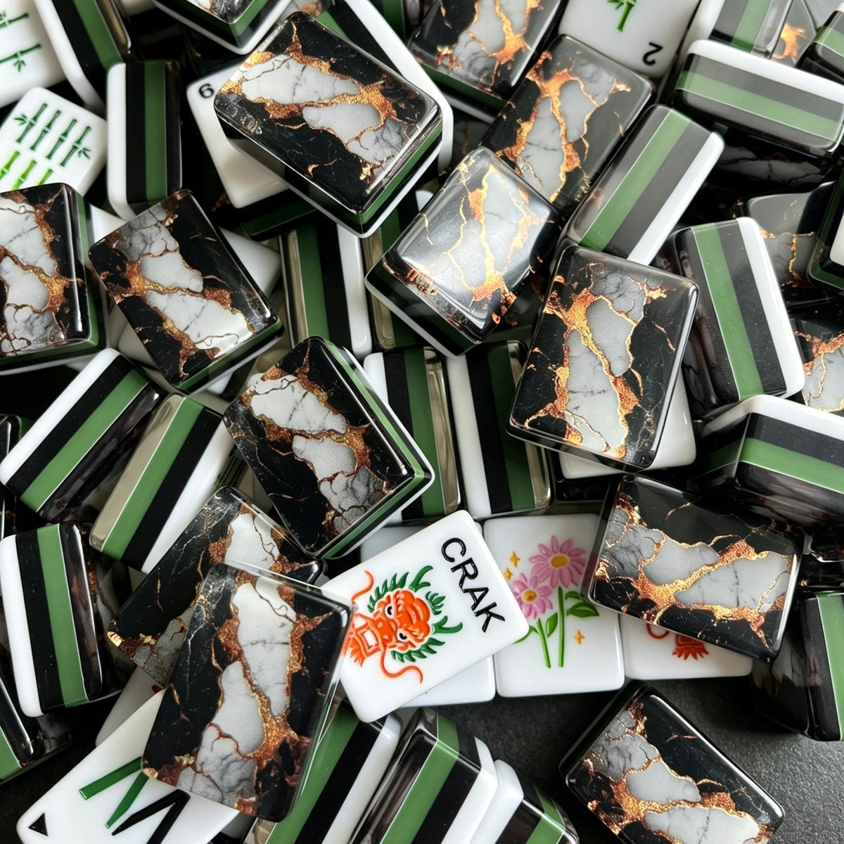 Black gold marble American mahjong tiles neatly arranged on dark marble tabletop, gold veined marble tile backs, green striped side edges, custom peacock bamboo, bear joker and colorful floral artwork