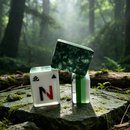 Three forest fern mahjong tiles arranged on weathered wood log, translucent green fern leaf backs, white tile face with North wind N letter design, sunbeam forest backdrop