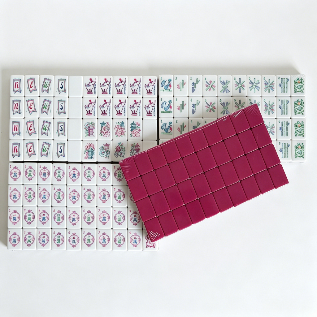 Artisan American Mahjong Set featuring hand-painted magenta tiles with detailed elephant engravings and grey-blue backs.