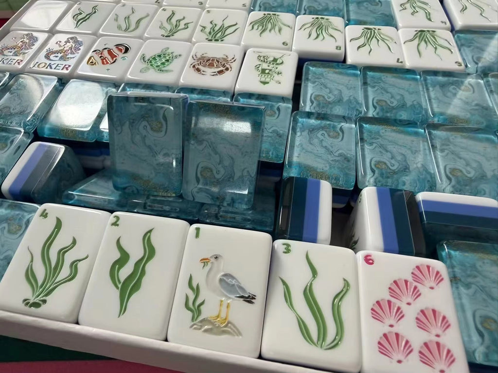 Coastal Mahjong Tiles Close-up - Seagull Sailboat Sea Turtle Seahorse and Tropical Wind Tiles on Sandy Background