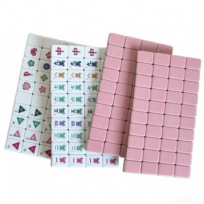 Close-up of Dusty Rose American Mahjong Set tiles with muted blush acrylic, elegant gold and white inlays, and compass wind design.