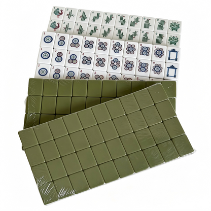 Detailed view of The Olive Grove American Mahjong Set by USA Mahjong Co. with 166 weighted acrylic tiles featuring earthy sage green backs.