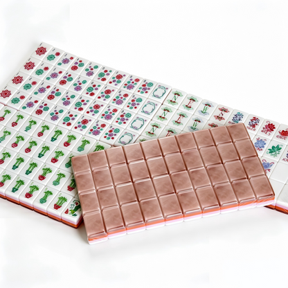 Detailed view of Rose Quartz American Mahjong Set by USA Mahjong Co. with 166 pink marbled acrylic tiles featuring gold inlays.