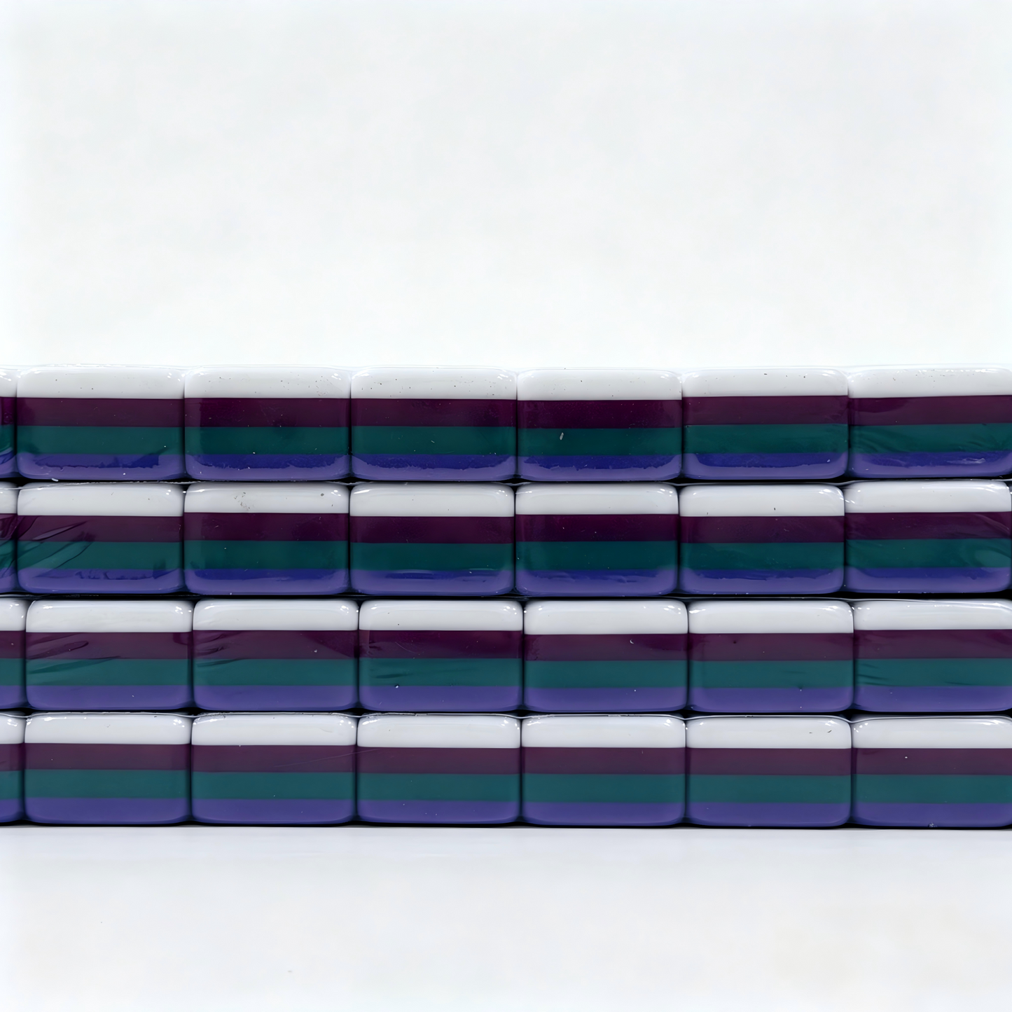 Side profile of 32g Galaxy Sparkle American Mahjong tiles with shimmering purple glitter backs, weighted for professional play.
