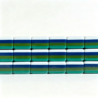 Side profile of teal Lagoon American Mahjong set with 32g weighted tiles, solid teal backs, and monkey jokers by USA Mahjong Co.