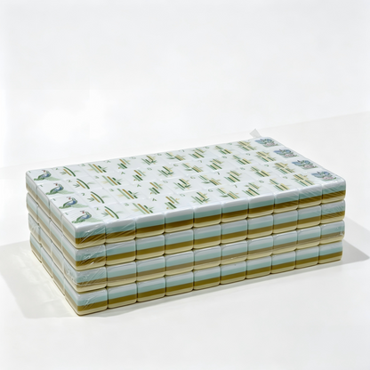 Side profile of Vanilla Bean Modern American Mahjong Set by USA Mahjong Co., featuring 32g weighted ivory tiles with gold and black inlays.