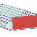 Modern American Mahjong Set by USA Mahjong Co. with 166 weighted tiles featuring vibrant coral red backs and intricate designs.