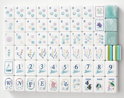 Flat top-down view of fully arranged Ocean Tide American mahjong tiles, custom nautical artwork including seashells, seaweed, sailboat and sea creature jokers, turquoise pearlescent tile backs with green-blue layered side stripes on clean white background